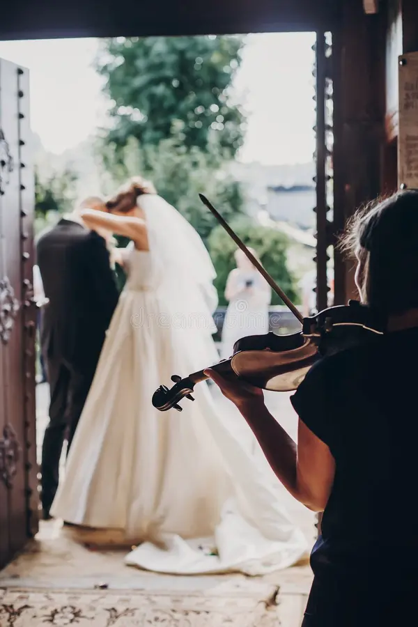 Musician playing violin at elegant wedding ceremony